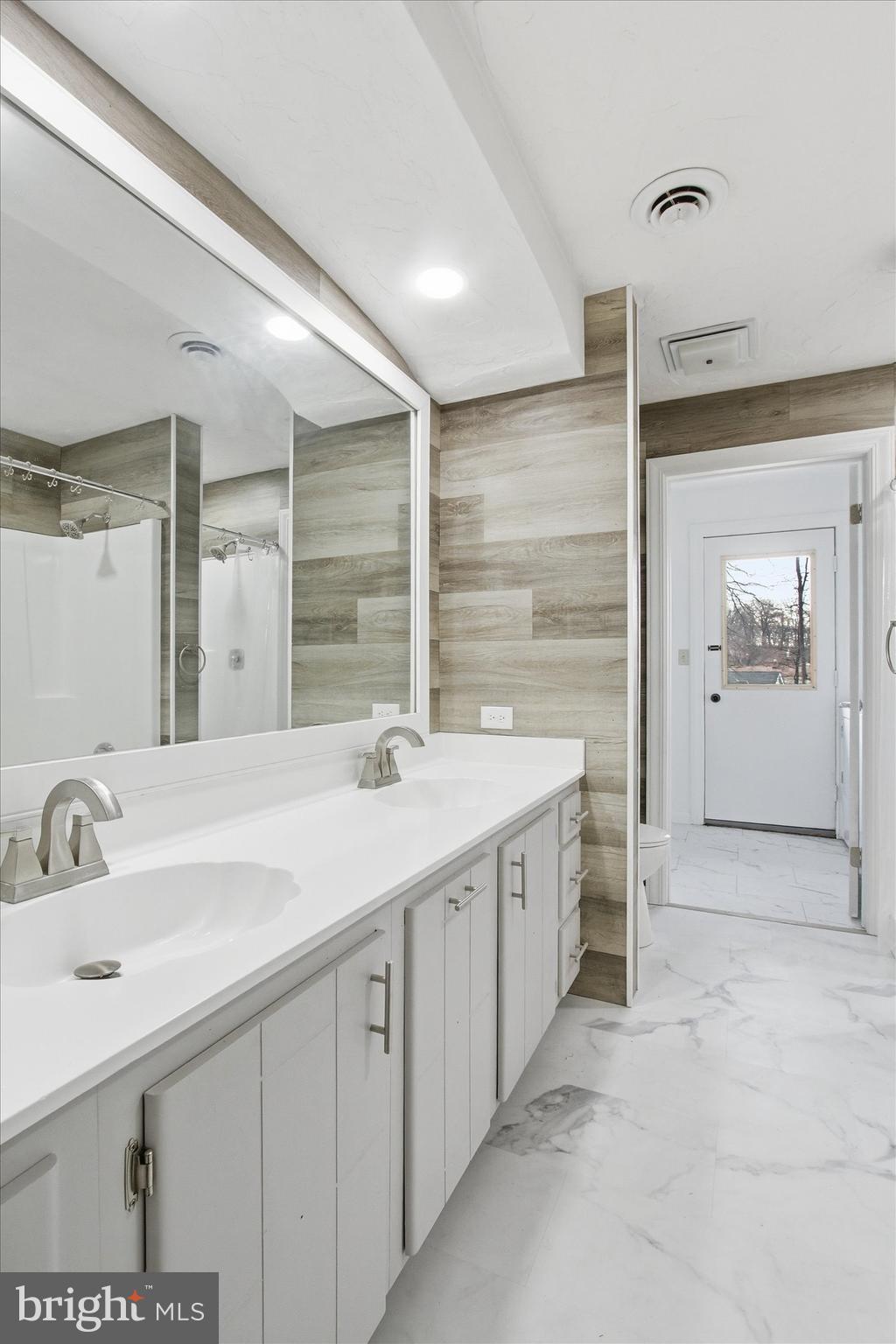 70 Laurel Drive Hanover, PA 17331 - Photo 31 of 48 a spacious bathroom with a double vanity sink a mirror and a shower