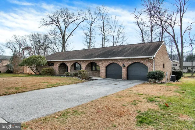 a front view of a house with yard and garage