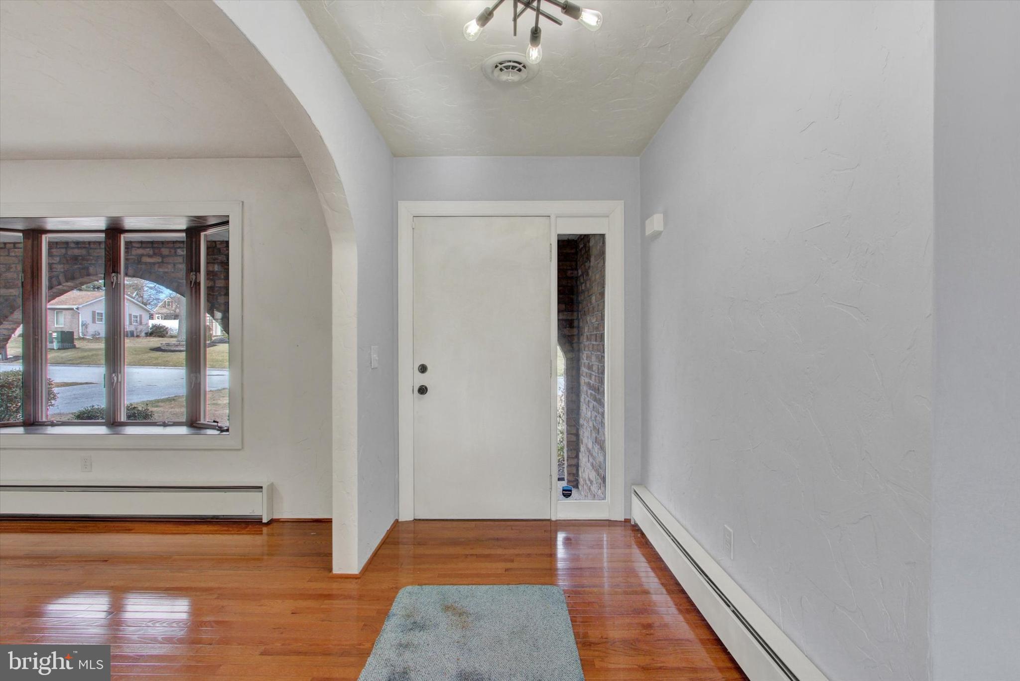 70 Laurel Drive Hanover, PA 17331 - Photo 4 of 48 a view of a hallway with wooden floor and a cabinet