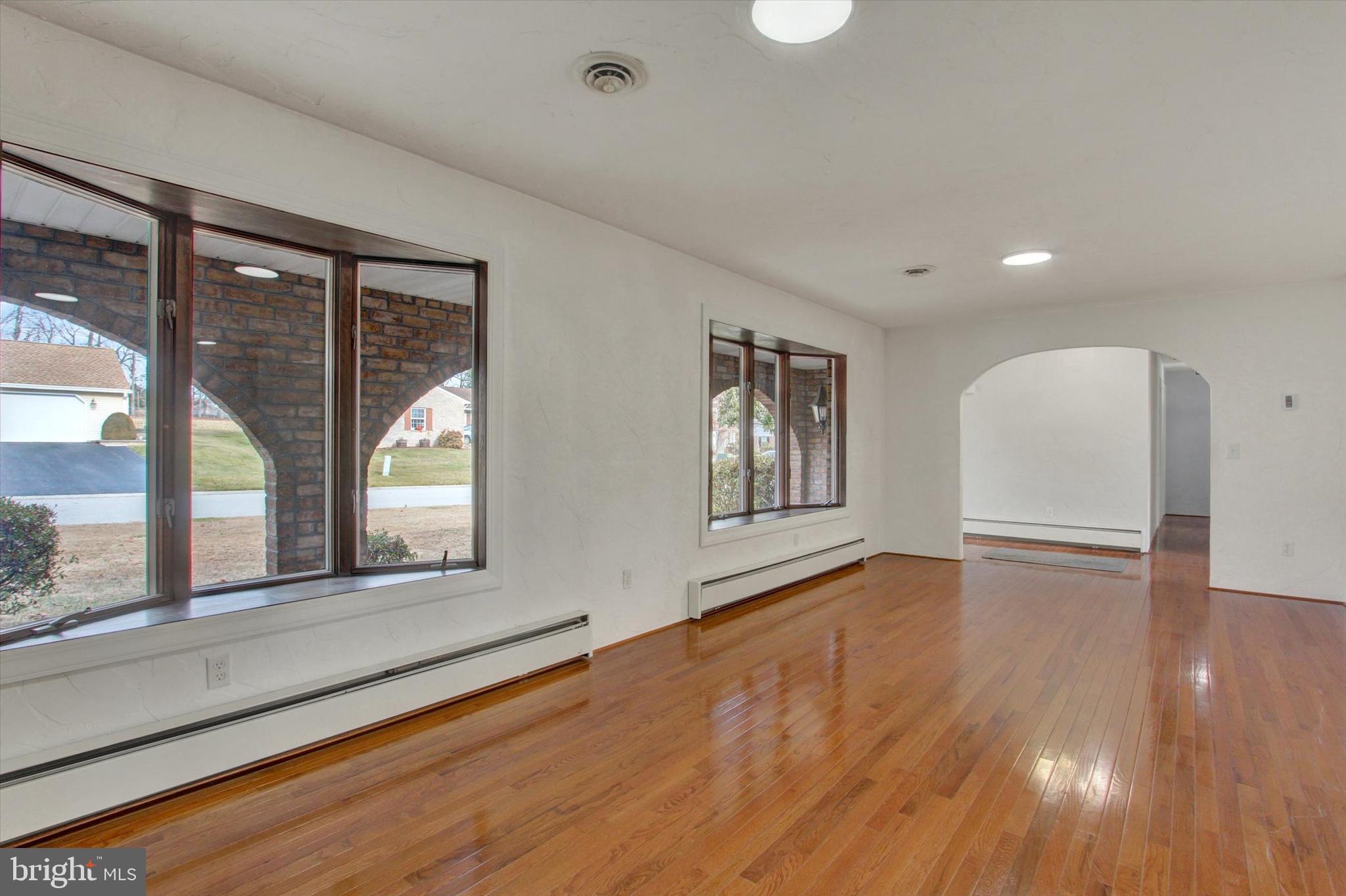 70 Laurel Drive Hanover, PA 17331 - Photo 8 of 48 a view of an empty room with a window and wooden floor