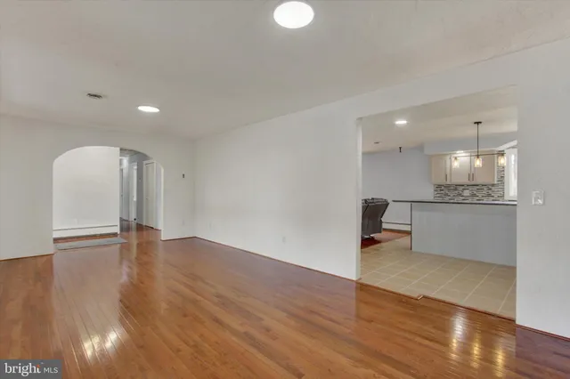 a large kitchen with granite countertop a sink a counter top stainless steel appliances and cabinets