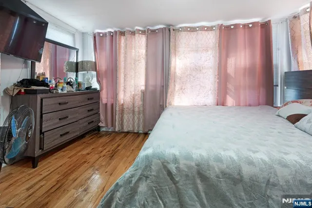 a bedroom with a bed and a mirror