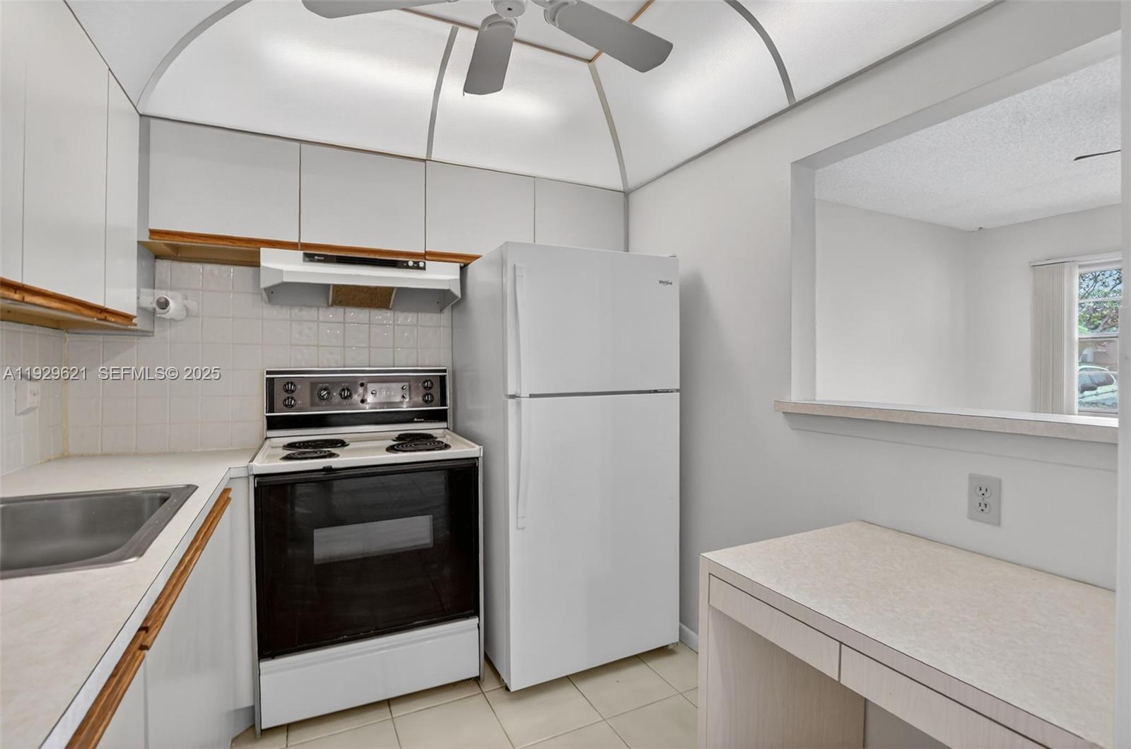 1008 Farnham North, Unit 1008 Deerfield Beach, FL 33442 - Photo 14 of 32 a kitchen with a stove sink and refrigerator