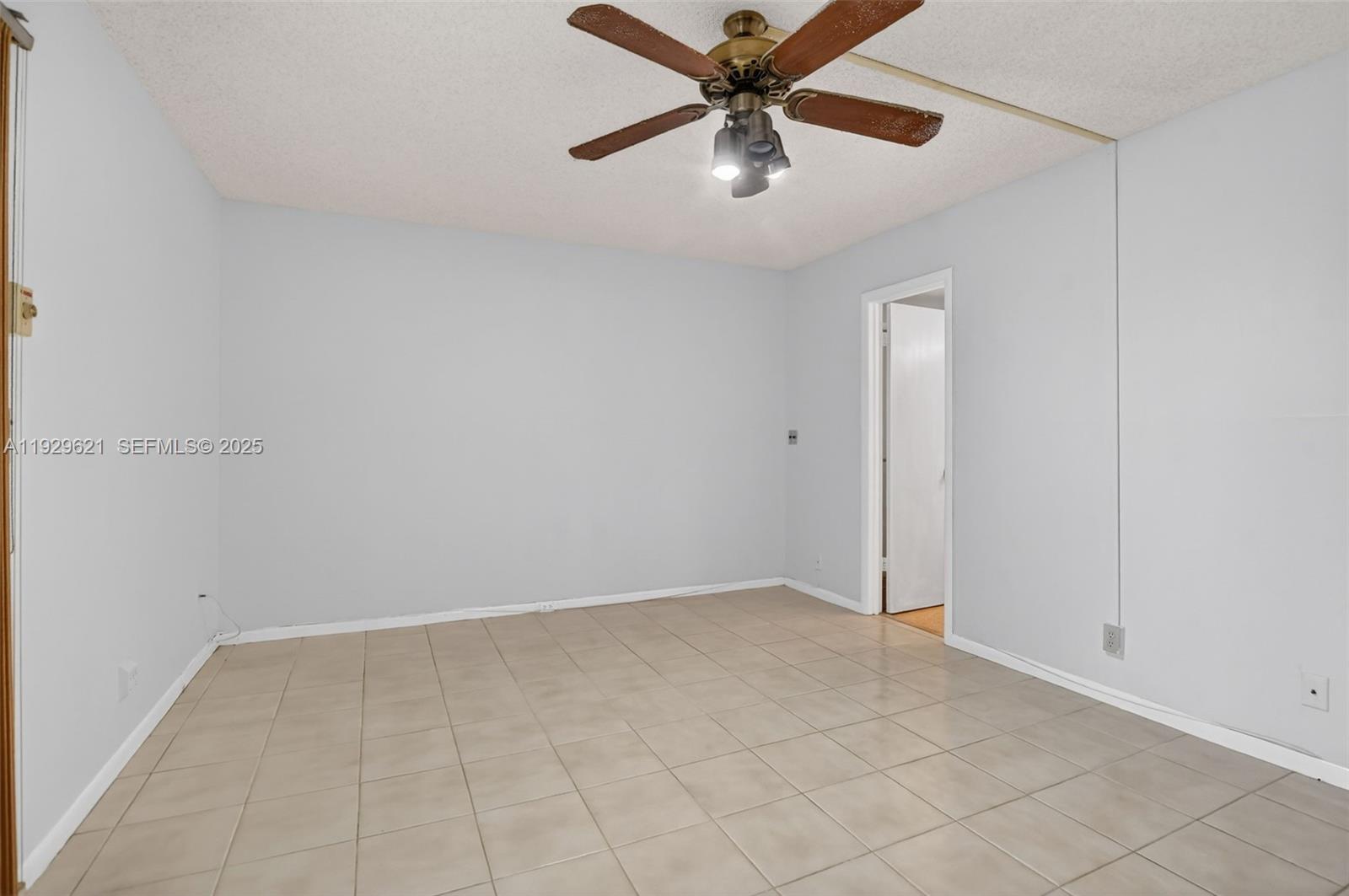 1008 Farnham North, Unit 1008 Deerfield Beach, FL 33442 - Photo 20 of 32 an empty room with chandelier fan
