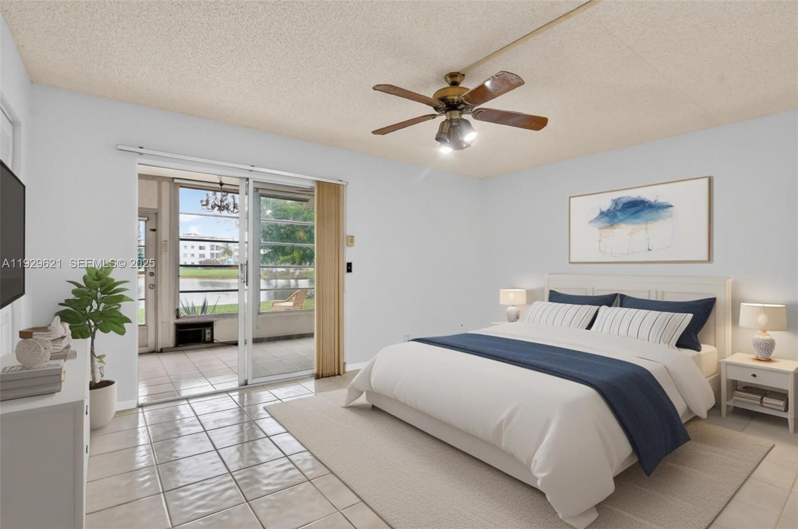 1008 Farnham North, Unit 1008 Deerfield Beach, FL 33442 - Photo 2 of 32 a bedroom with a large bed and a window