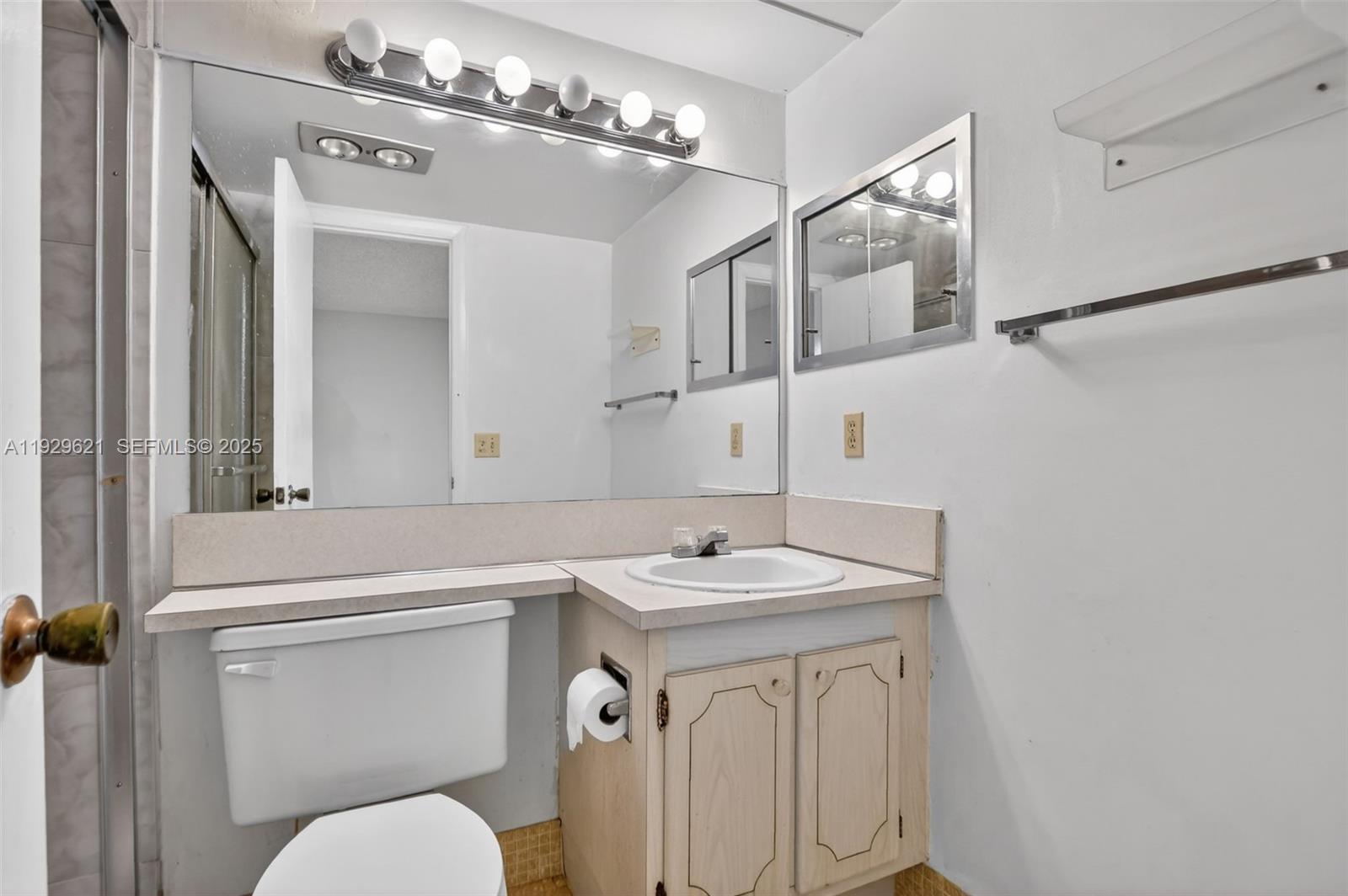 1008 Farnham North, Unit 1008 Deerfield Beach, FL 33442 - Photo 23 of 32 a bathroom with a sink a toilet a mirror and shower