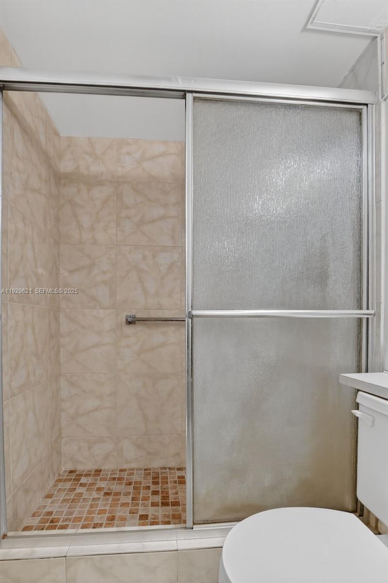 1008 Farnham North, Unit 1008 Deerfield Beach, FL 33442 - Photo 25 of 32 a white toilet sitting next to a shower