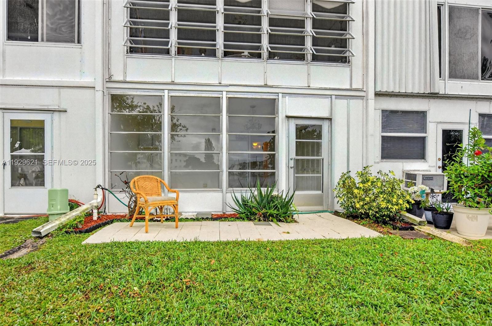 1008 Farnham North, Unit 1008 Deerfield Beach, FL 33442 - Photo 28 of 32 a view of a two chair in front of house