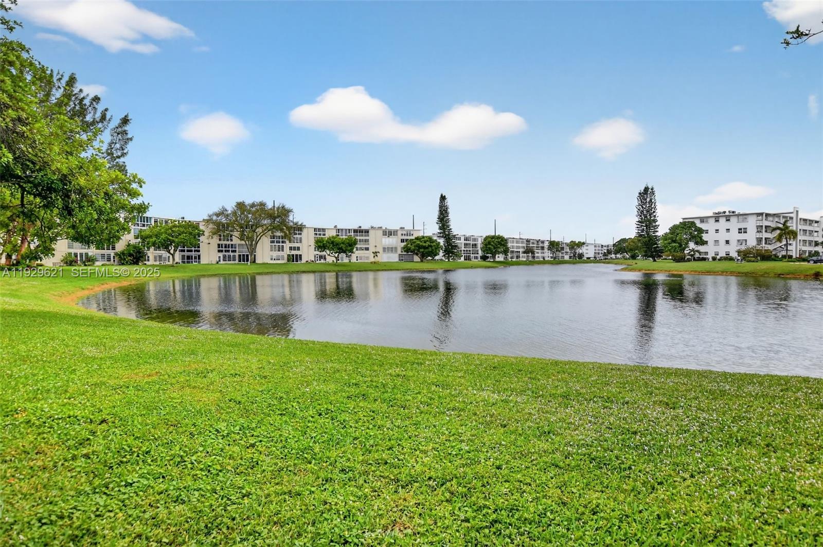 1008 Farnham North, Unit 1008 Deerfield Beach, FL 33442 - Photo 29 of 32 a view of a lake with houses in the back