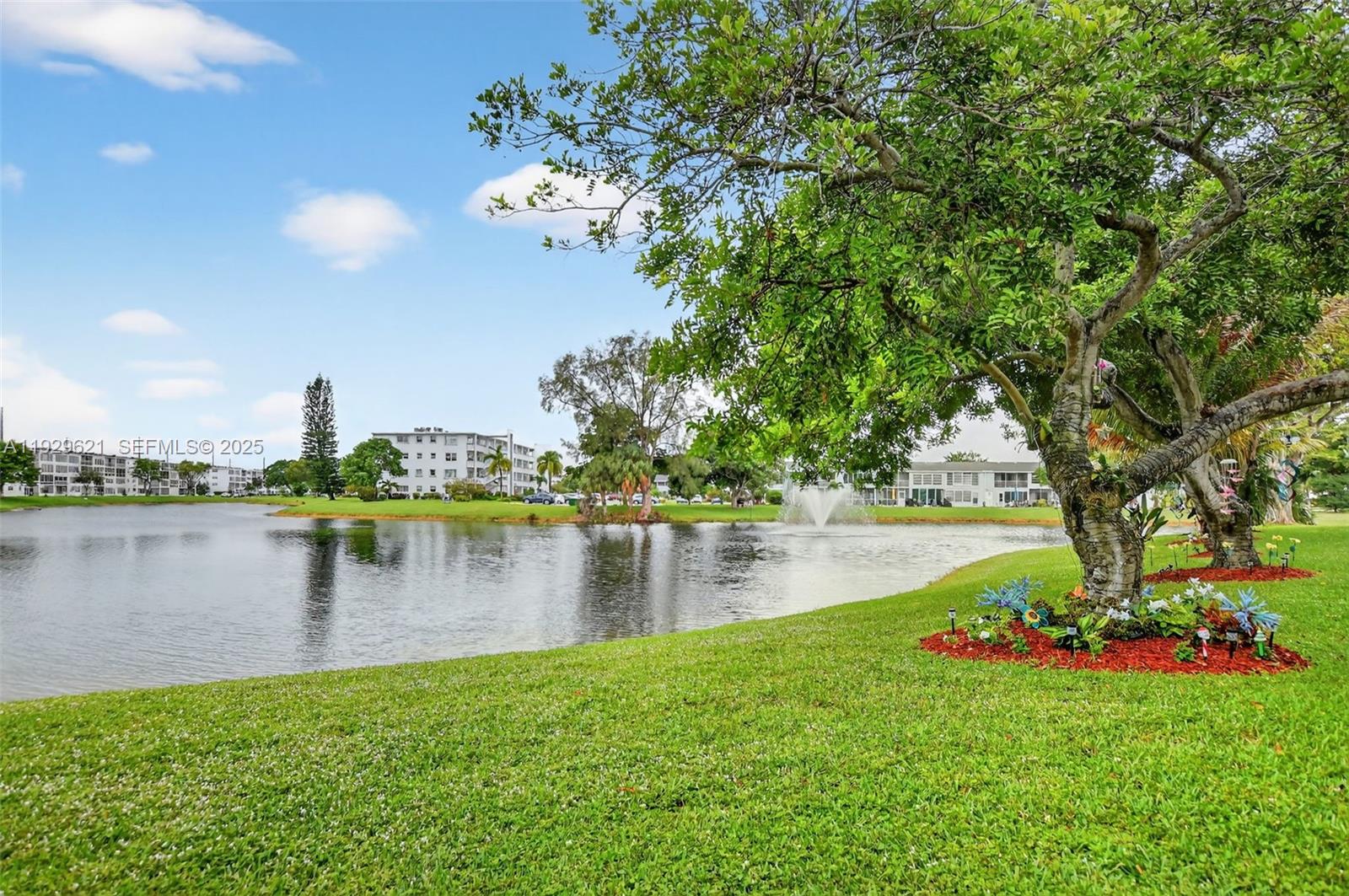 1008 Farnham North, Unit 1008 Deerfield Beach, FL 33442 - Photo 31 of 32 a view of a lake with a house in the background