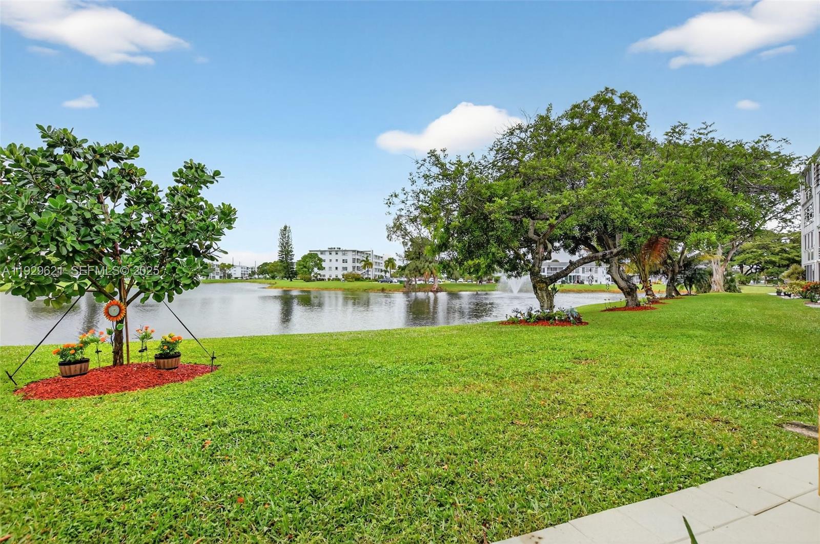 1008 Farnham North, Unit 1008 Deerfield Beach, FL 33442 - Photo 4 of 32 a view of a garden with a building in the background