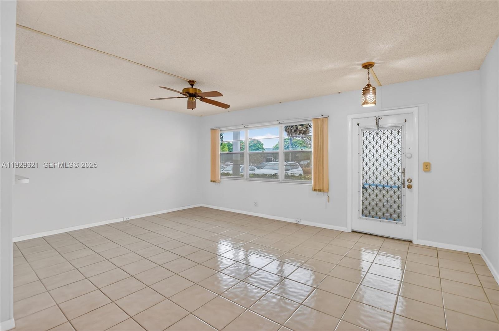 1008 Farnham North, Unit 1008 Deerfield Beach, FL 33442 - Photo 8 of 32 an empty room with windows and ceiling fan