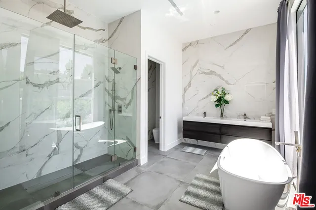 a living room with a bathtub and a potted plant