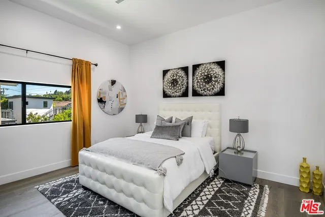 a bedroom with a large bed and a window