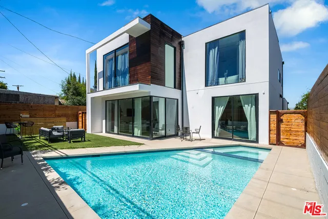 a view of a house with backyard porch and sitting area