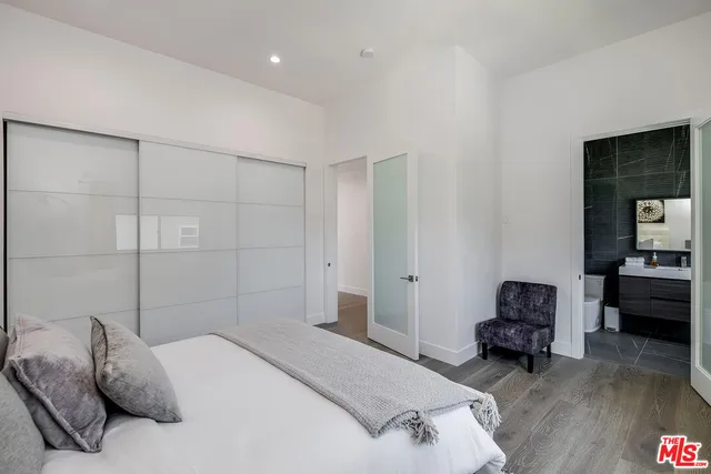 a bedroom with a bed and a chair