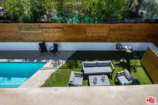 an aerial view of a house with a garden and lake view