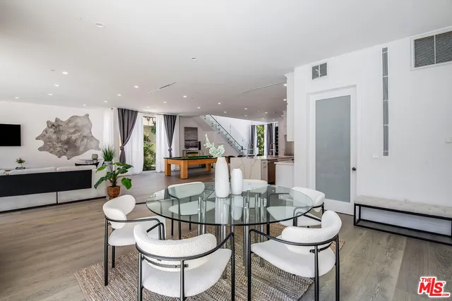 a dining room with furniture and wooden floor