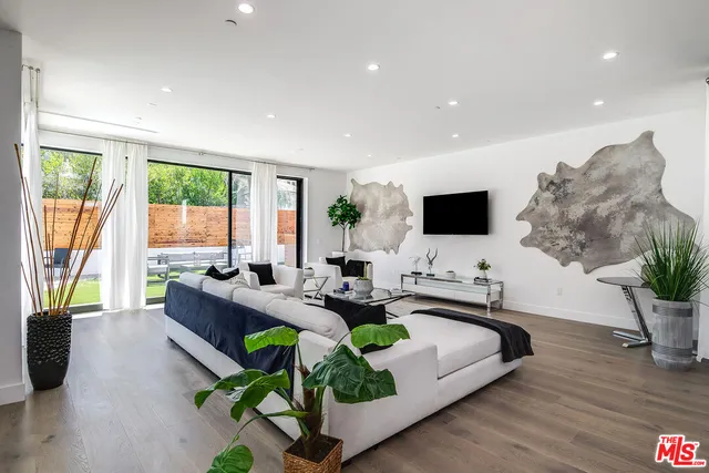 a living room with fireplace furniture and a flat screen tv