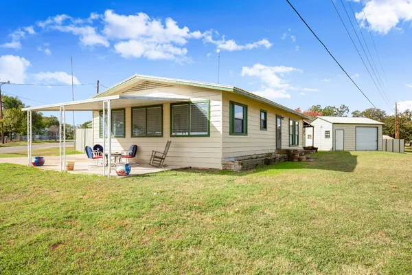 a view of a house with backyard porch and furniture