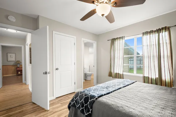 a bedroom with a bed and a chandelier