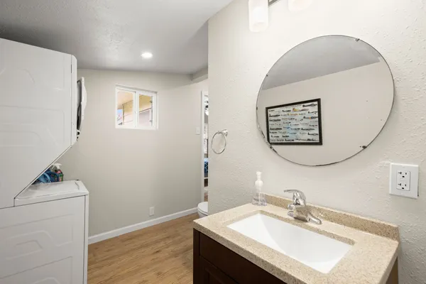 a bathroom with a sink vanity and a mirror