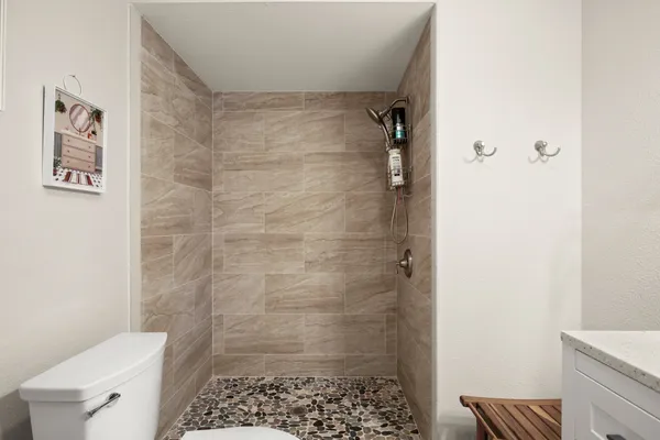 a bathroom with a shower and a toilet