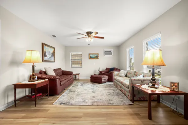 a living room with furniture a lamp and a table