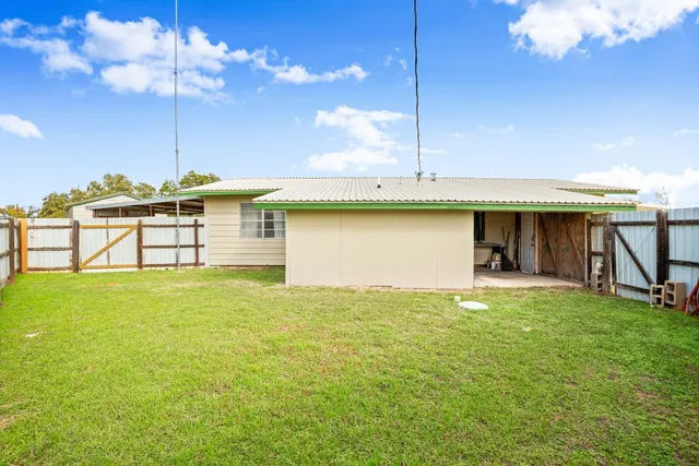 a view of a house with a backyard patio and entertaining space