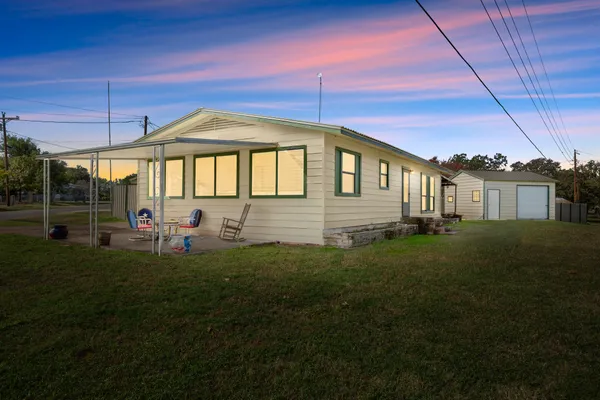 a front view of a house with a yard