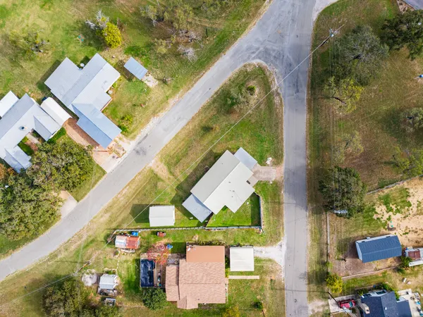 an aerial view of a house with a swimming pool