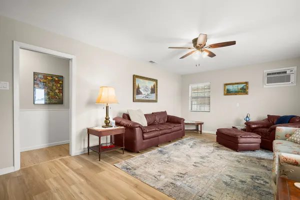 a living room with furniture a rug and a window