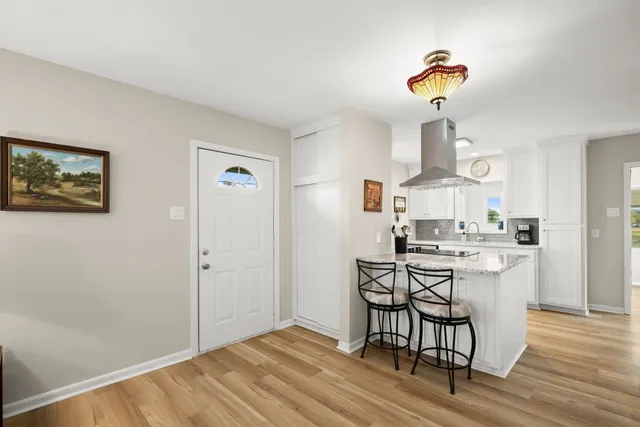 a kitchen with a table and chairs in it