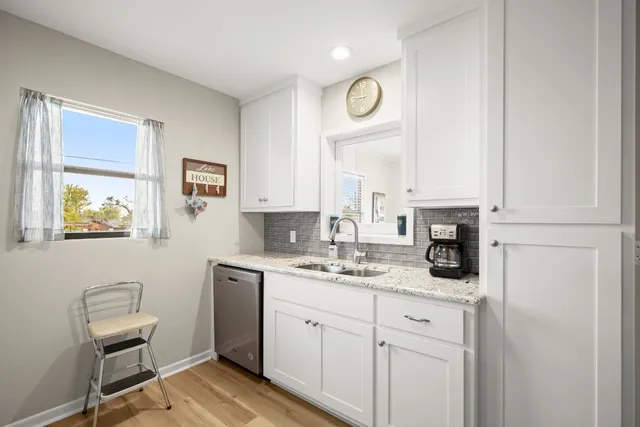 a kitchen with cabinets appliances and a window