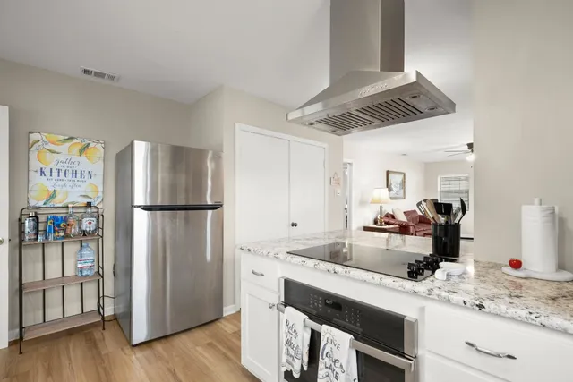 a kitchen with a refrigerator and a sink