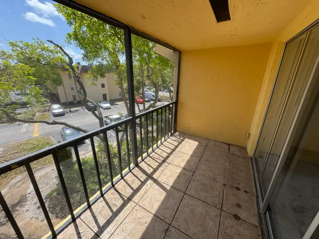 a view of balcony with wooden floor