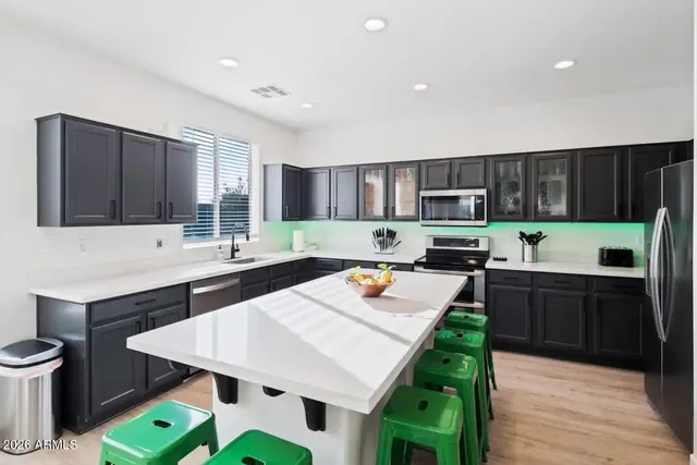 a kitchen with kitchen island granite countertop wooden cabinets a stove top oven a sink and dishwasher