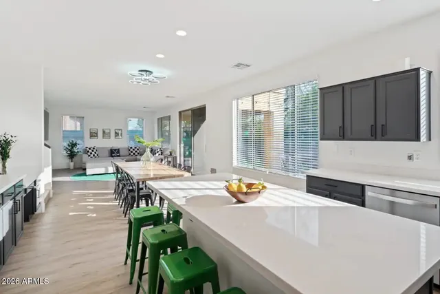 a large white kitchen with a large window