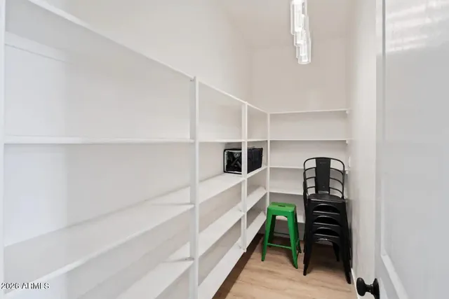a kitchen with a refrigerator and white cabinets