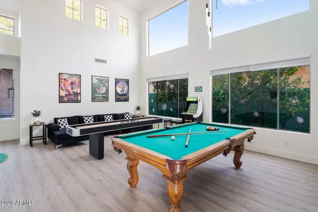a room with pool tables and windows