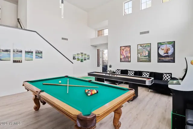 a room with furniture pool table and a window