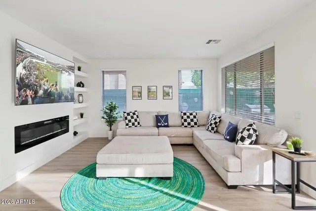 a living room with furniture fireplace and window