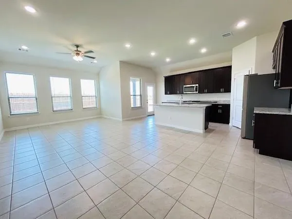 a view of kitchen with microwave a stove and cabinets