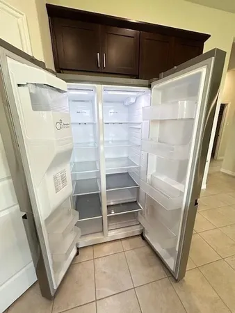 a view of walk in closet with empty racks