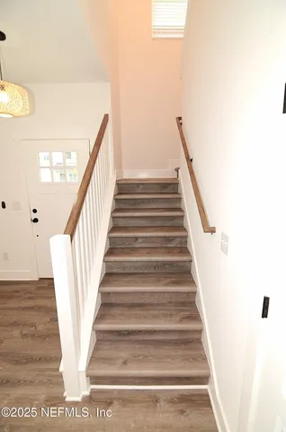 a view of a room with a ceiling fan and a window