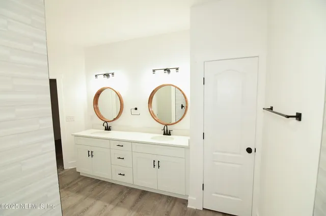 a bathroom with a double vanity sink and a mirror