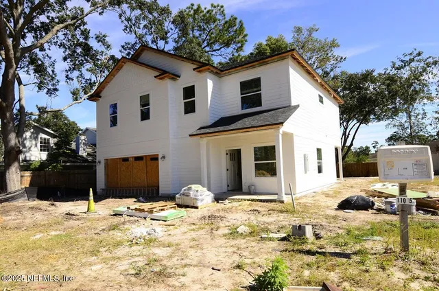 a view of a white house with a yard