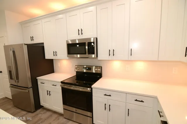 a living room with a chandelier furniture and a window