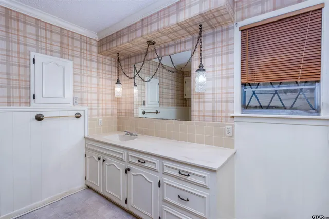 a bathroom with a sink and a mirror