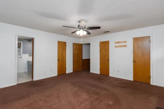 a view of a livingroom with a chandelier fan